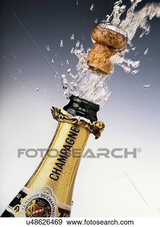 Champagne Bottle With Cork Popping Out Stock Photo U48626469