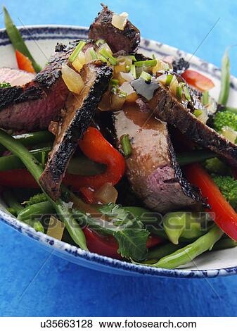 Chargrilled fillet steak strips with vegetable salad honey ginger dressing View Large Photo Image Stock Photo - Chargrilled fillet steak strips with vegetable salad honey ginger dressing. Fotosearch