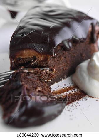 Stock Image - Chocolate fudge cake slice. Fotosearch