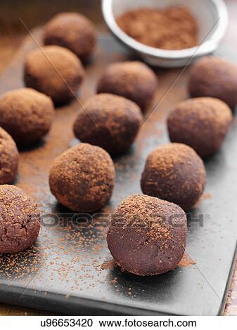Stock Image - Chocolate truffles dusted with cocoa powder. Fotosearch