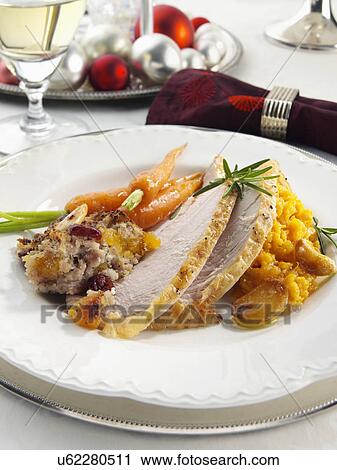Stock Image - Christmas dinner turkey stuffing carrots and mashed sweet potato. Fotosearch