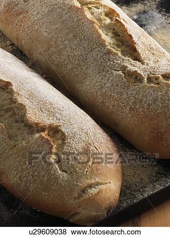 Stock Photo - Ciabatta on a baking tray. Fotosearch