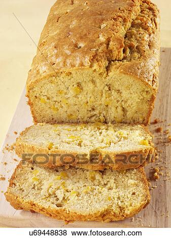 Cooked Cornbread Loaf On Wooden Board With Two Cut Slices View Large Photo Image Stock Photo - Cooked Cornbread Loaf On Wooden Board With Two Cut Slices. Fotosearch