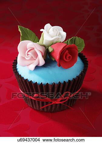 Picture - Cupcake With Pink, White And Red Iced Roses On Turquoise Topping, Red Velvet Tabletop. Fotosearch