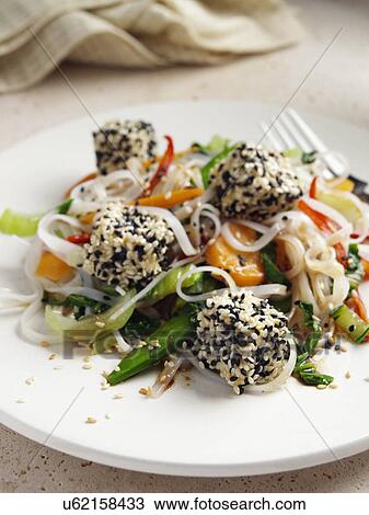 Deep fried tofu coated in black and white sesame seeds rice noodles stir fried vegetables carrots scallions sugar snaps Japanese main meals View Large Photo Image Stock Image - Deep fried tofu coated in black and white sesame seeds rice noodles stir fried vegetables carrots scallions sugar snaps Japanese main meals. Fotosearch