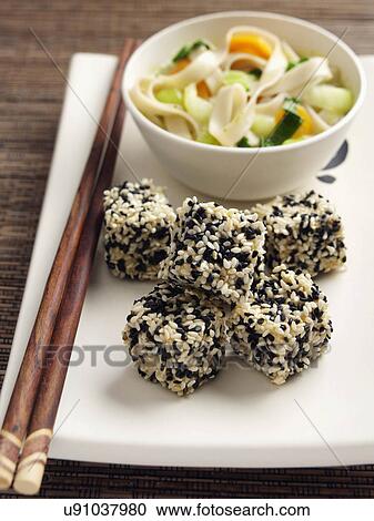 Deep fried tofu coated in black and white sesame seeds rice noodles stir fried vegetables carrots scallions sugar snaps Japanese main meals View Large Photo Image Stock Image - Deep fried tofu coated in black and white sesame seeds rice noodles stir fried vegetables carrots scallions sugar snaps Japanese main meals. Fotosearch
