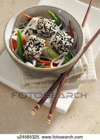 Stock Photography - Deep fried tofu coated in black and white sesame seeds rice noodles stir fried vegetables carrots scallions sugar snaps Japanese main meals. Fotosearch