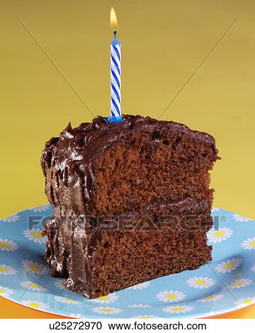 Stock Image - Devil'S Food Cake, Cut Slice Of Chocolate Cake Covered With Chocolate Butter Cream Frosting With Blue Candle On Top, Yellow Background. Fotosearch