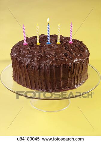 Devil'S Food Cake, Whole Chocolate Cake Covered With Chocolate Butter Cream Frosting With Candles, On Glass Serving Plate, Yellow Background View Large Photo Image Stock Photography - Devil'S Food Cake, Whole Chocolate Cake Covered With Chocolate Butter Cream Frosting With Candles, On Glass Serving Plate, Yellow Background. Fotosearch