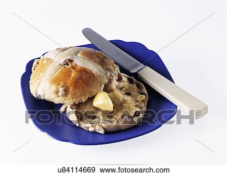 Stock Photo - Easter hot cross bun on a blue plate on a white background. Fotosearch
