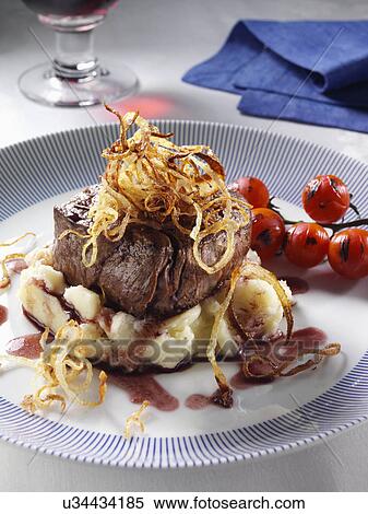 Stock Photography - Fillet steak tomatoes mashed potato caramelised onions balsamic vinegar. Fotosearch