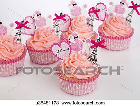 French Or Parisian Style Cupcakes In Pink Paper Case With Piped Pink Butter Cream Icing, With Toppers Of Eiffel Tower, Parisian White Poodle And Heart With Words Je T'Aime- I Love You, On White View Large Photo Image Stock Photo - French Or Parisian Style Cupcakes In Pink Paper Case With Piped Pink Butter Cream Icing, With Toppers Of Eiffel Tower, Parisian White Poodle And Heart With Words Je T'Aime- I Love You, On White. Fotosearch