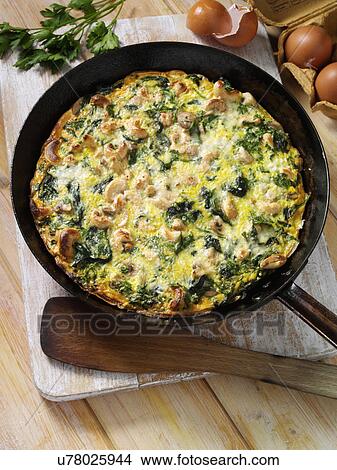 Picture - Frittata with mushrooms spinach and cashews. Fotosearch