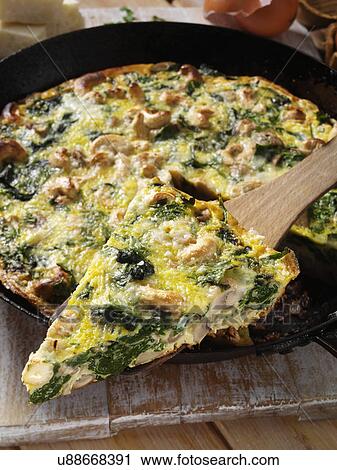 Stock Image - Frittata with mushrooms spinach onions and cashews. Fotosearch