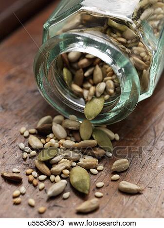 Stock Image - Glass bottle with seeds. Fotosearch