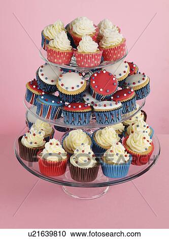 Glass Cake Stand Full Of Decorated Cupcakes In Red, Blue, Brown And Pink Cake Cases, Pink Background View Large Photo Image Stock Image - Glass Cake Stand Full Of Decorated Cupcakes In Red, Blue, Brown And Pink Cake Cases, Pink Background. Fotosearch