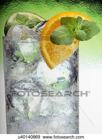 Glass Tumbler Filled With Clear Iced Drink, Orange And Lemon Slice Garnish With Mint, View Large Photo Image Stock Photo - Glass Tumbler Filled With Clear Iced Drink, Orange And Lemon Slice Garnish With Mint,. Fotosearch