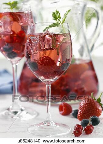 Glasses and a jug of berry sangria View Large Photo Image Stock Image - Glasses and a jug of berry sangria. Fotosearch