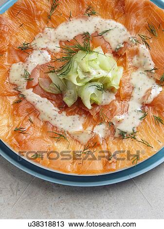 Stock Image - Gravlax smoked salmon with dill cucumber mustard dressing Marco Pierre White recipe. Fotosearch