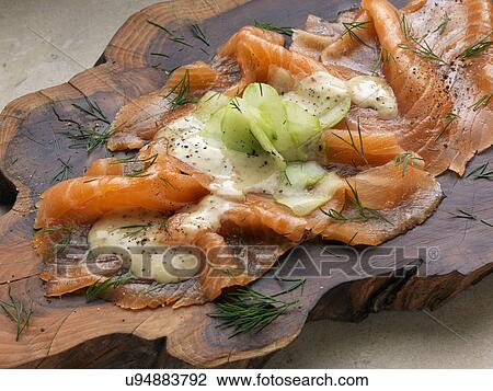 Stock Image - Gravlax smoked salmon with dill cucumber mustard dressing Marco Pierre White recipe. Fotosearch