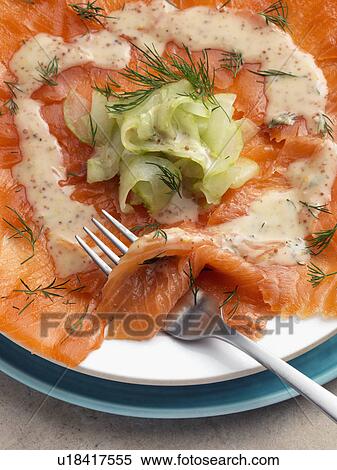 Stock Photography - Gravlax smoked salmon with dill cucumber mustard dressing Marco Pierre White recipe. Fotosearch