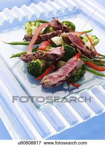Griddled sirloin steak strips and vegetable salad View Large Photo Image Stock Photo - Griddled sirloin steak strips and vegetable salad. Fotosearch