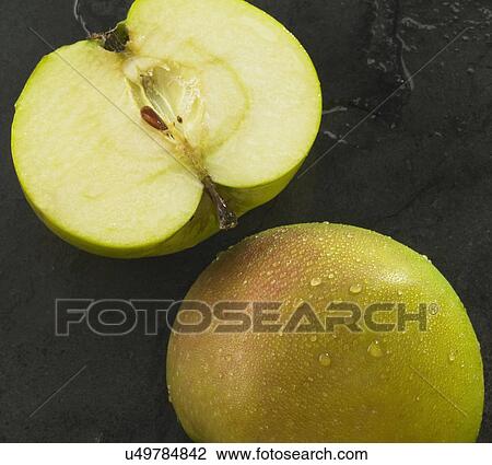 Stock Image - Halved Apple On Slate Background. Fotosearch