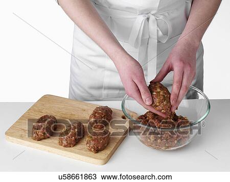 Stock Image - Hands forming kebabs. Fotosearch