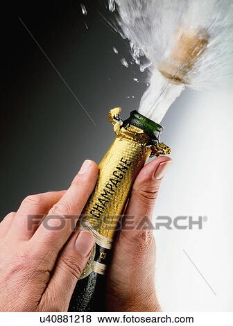 Hands Holding Champagne Bottle With Cork Popping Out View Large Photo Image Stock Photo - Hands Holding Champagne Bottle With Cork Popping Out. Fotosearch