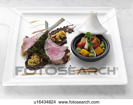 Herb crust Moroccan lamb chops with vegetable tagine View Large Photo Image Picture - Herb crust Moroccan lamb chops with vegetable tagine. Fotosearch
