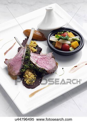 Herb crust Moroccan lamb chops with vegetable tagine View Large Photo Image Stock Photography - Herb crust Moroccan lamb chops with vegetable tagine. Fotosearch