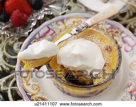 Individual blueberry clafoutis on a garden table View Large Photo Image Stock Photo - Individual blueberry clafoutis on a garden table. Fotosearch