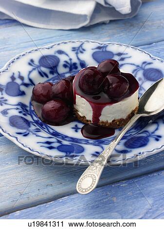 Stock Image - Individual cherry cheesecake on an antique plate. Fotosearch