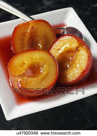 Stock Photo - Individual portion of Boozy plums dessert. Fotosearch