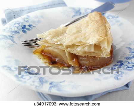 Stock Image - Individual portion of caramelized apple pie on an antique plate. Fotosearch
