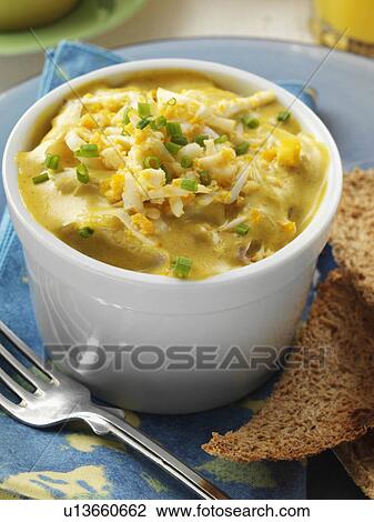 Stock Image - Individual portion of gourmet kedgeree in a white ramekin. Fotosearch