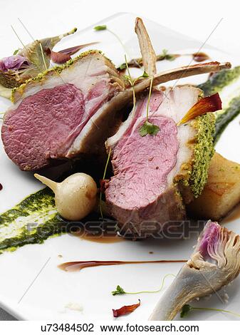 Stock Image - Individual portion of lamb rack. Fotosearch