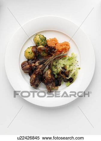 Individual portion of lamb ribs new potatoes cabbage and carrot swede mash View Large Photo Image Stock Photography - Individual portion of lamb ribs new potatoes cabbage and carrot swede mash. Fotosearch