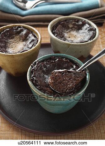 Stock Image - Individual portions of banana fudge pudding. Fotosearch