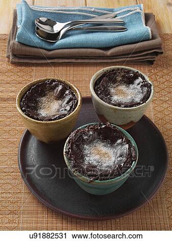 Stock Image - Individual portions of banana fudge pudding. Fotosearch