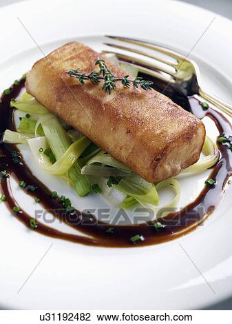 Individual serving of fish paupiette sauteed leeks with borolo sauce View Large Photo Image Stock Image - Individual serving of fish paupiette sauteed leeks with borolo sauce. Fotosearch