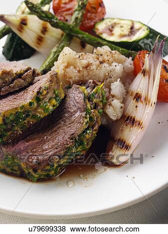 Lamb rump with a herb and mustard crust asparagus shallots courgettes and tomatoes View Large Photo Image Stock Photo - Lamb rump with a herb and mustard crust asparagus shallots courgettes and tomatoes. Fotosearch