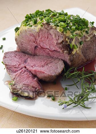 Stock Image - Lamb rump with a herb crust. Fotosearch