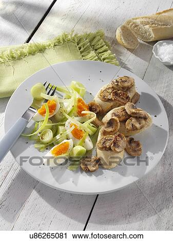 Stock Image - Leek egg salad with mushrooms and bread. Fotosearch