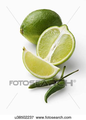 Limes and chillies on a white background View Large Photo Image Stock Photo - Limes and chillies on a white background. Fotosearch