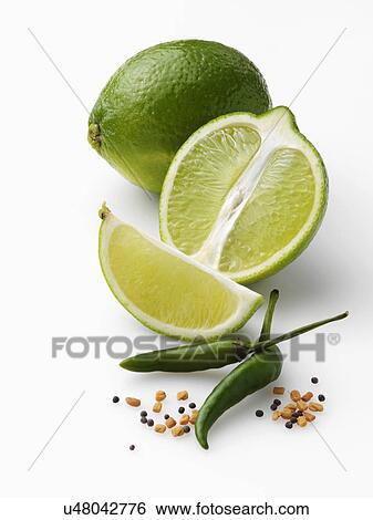 Stock Photograph - Limes and chillies on a white background. Fotosearch