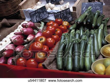 Local produce in Cavalaire market stall, Provence, France. Tomatoes, courgettes, zucchini, onions, vegetables. View Large Photo Image Stock Photo - Local produce in Cavalaire market stall, Provence, France. Tomatoes, courgettes, zucchini, onions, vegetables.. Fotosearch