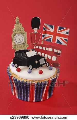 London Themed British Celebration Cupcake, White Iced Sponge Fairy Cake, Topped With Red And Blue Sprinkles Small Union Jack Flag, Big Ben, London Taxi, Red Bus And Guardsman, On Red With Union Jack Bunting View Large Photo Image Stock Image - London Themed British Celebration Cupcake, White Iced Sponge Fairy Cake, Topped With Red And Blue Sprinkles Small Union Jack Flag, Big Ben, London Taxi, Red Bus And Guardsman, On Red With Union Jack Bunting. Fotosearch