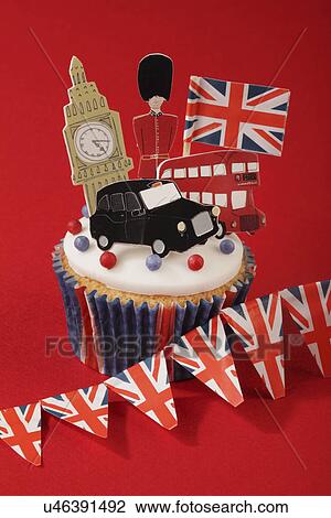 London Themed British Celebration Cupcake, White Iced Sponge Fairy Cake, Topped With Red And Blue Sprinkles Small Union Jack Flag, Big Ben, London Taxi, Red Bus And Guardsman, On Red With Union Jack Bunting View Large Photo Image Stock Image - London Themed British Celebration Cupcake, White Iced Sponge Fairy Cake, Topped With Red And Blue Sprinkles Small Union Jack Flag, Big Ben, London Taxi, Red Bus And Guardsman, On Red With Union Jack Bunting. Fotosearch