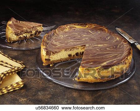 Stock Image - Marbled pumpkin cheesecake. Fotosearch